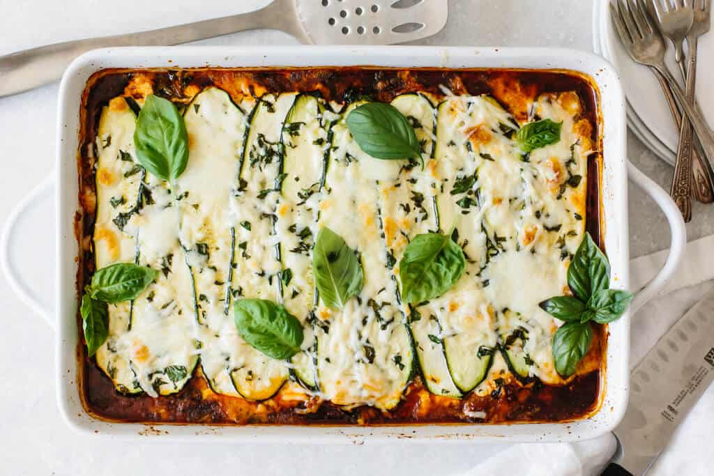 Zucchini lasagna in a white baking dish.