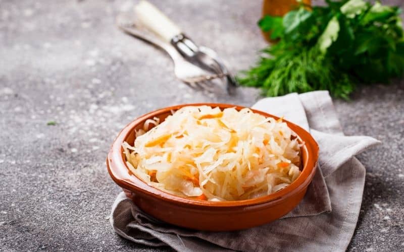 Sauerkraut in a bowl placed on top of a napkin.