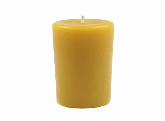 A yellow candle in a white background.