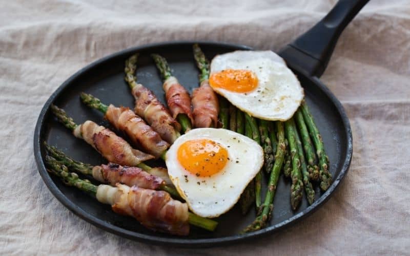 carnivore keto Eggs, bacon and vegetables on a pan.