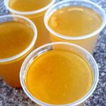 4 servings of bone broth in clear cups.