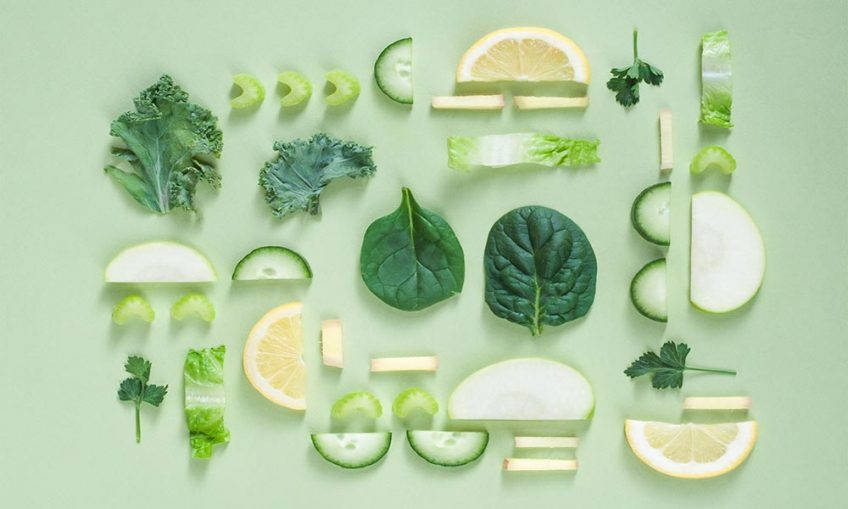 Various vegetable and fruits laid out on a green background.