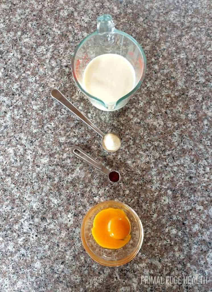 Cream in a container and an egg in another container.