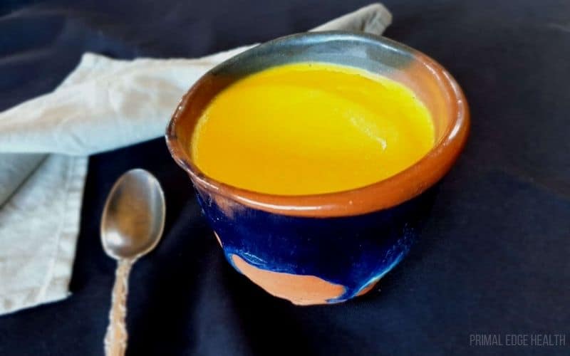 A single serving of egg pudding with a spoon and white cloth.