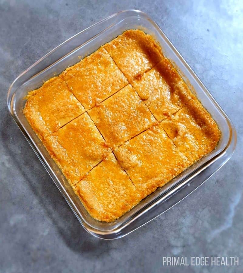A glass dish of carnivore cake sliced into portions.