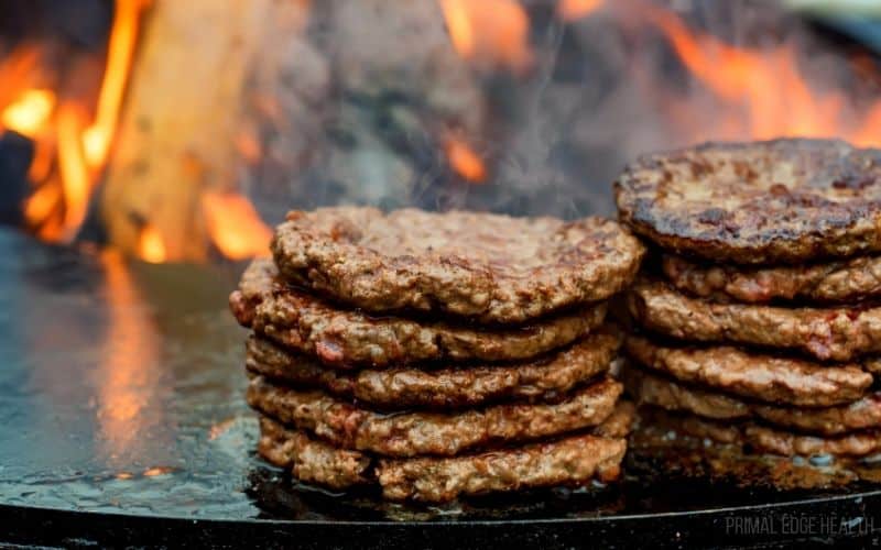 A stack of patties on a dark surface.