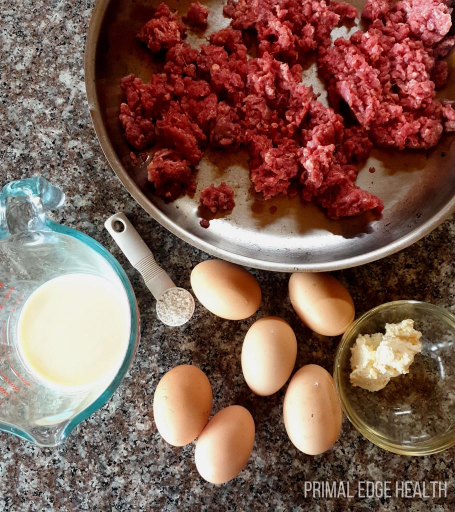 Ground beef casserole being prepped in a steel bowl.
