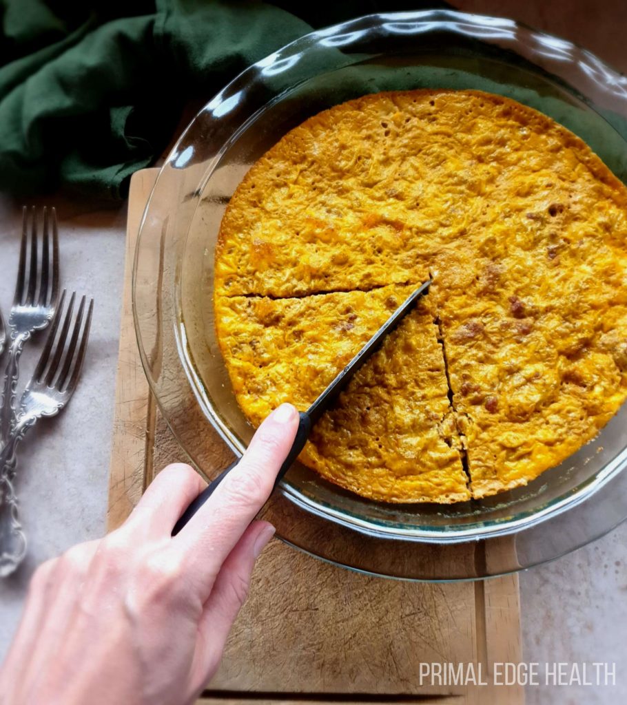 Carnivore casserole being sliced in a glass dish.