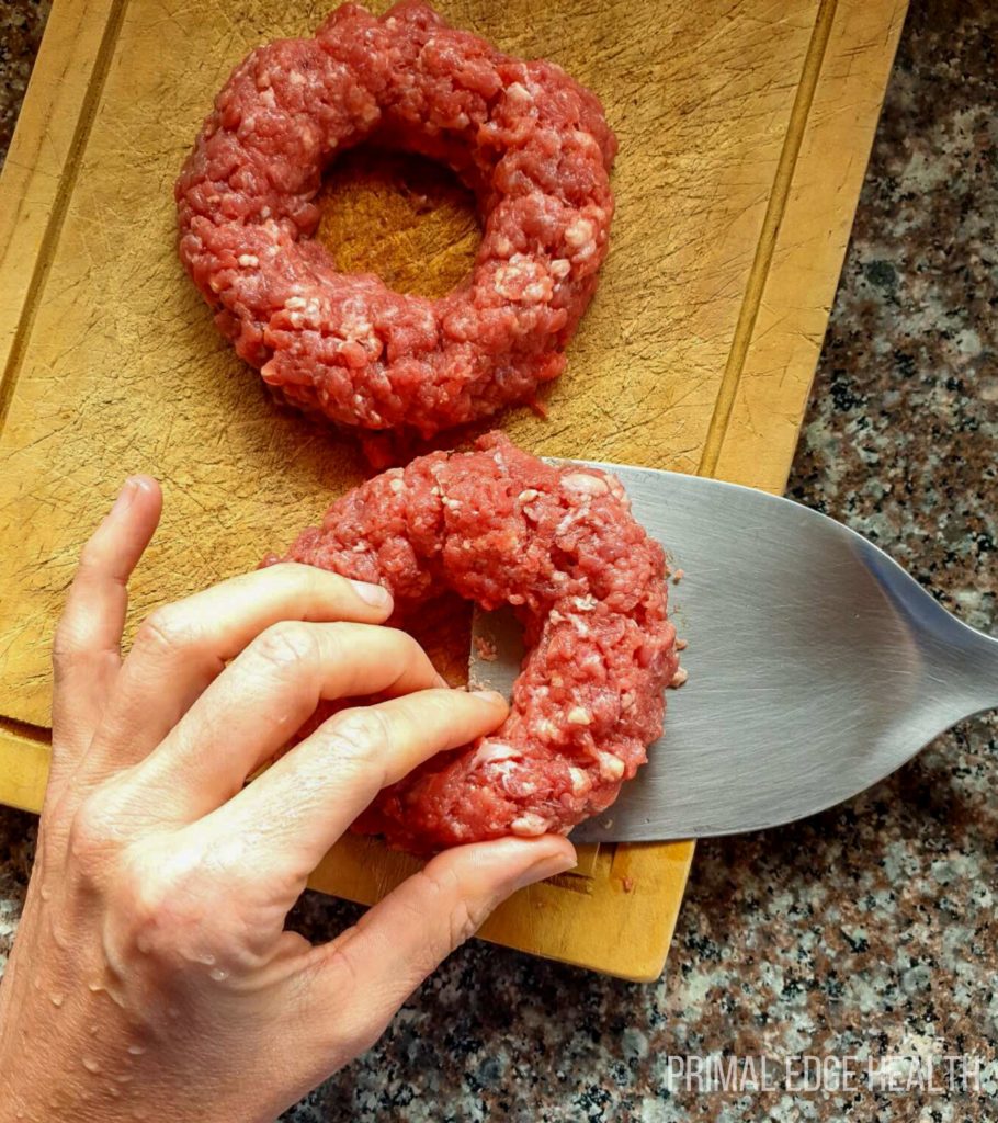 Carnivore egg in a hole being prepared on a wooden board.