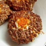 3 pieces of carnivore egg in a hole on a white plate.