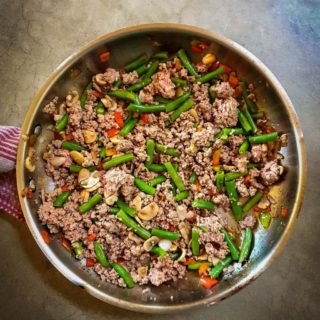 Keto Ground Beef Stir Fry in a pan on a grey surface.