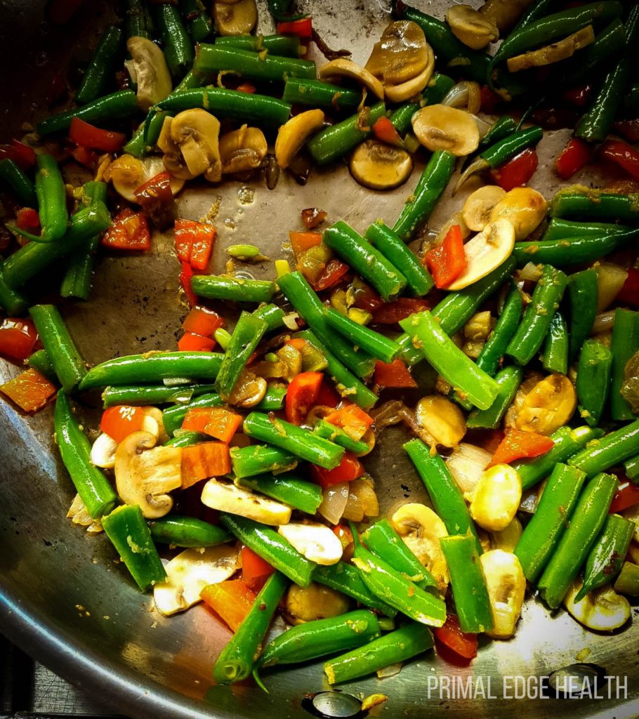 Vegetables and garnish being sauted.