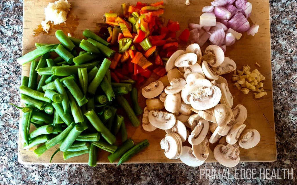 Raw ingredients and garnishes on a wooden board.