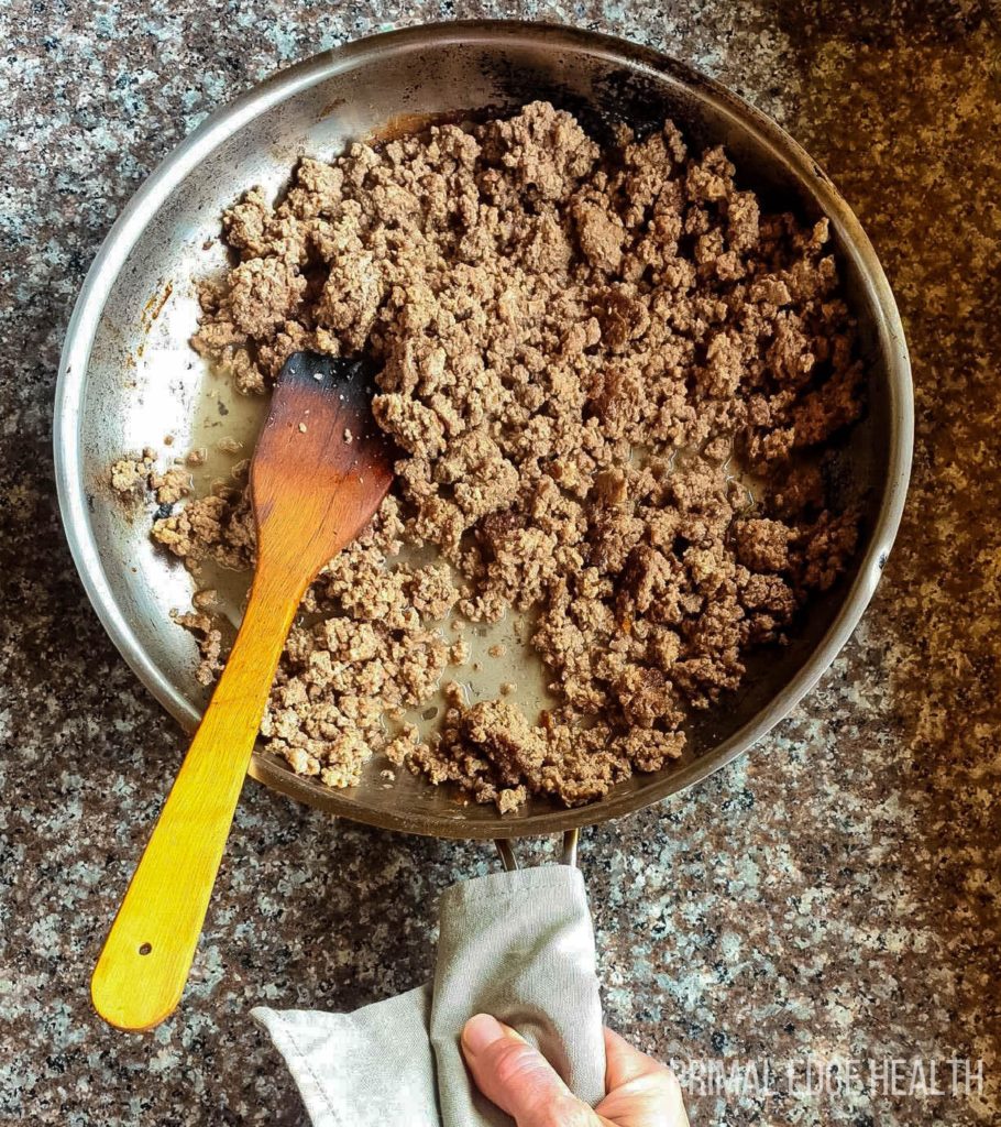 Carnivore ground beef stroganoff in a pan with a wooden spoon.