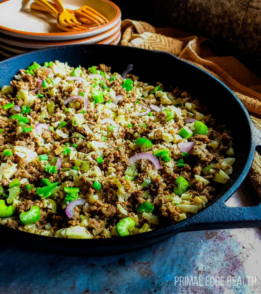 Dirty rice with ground beef in a black pan.