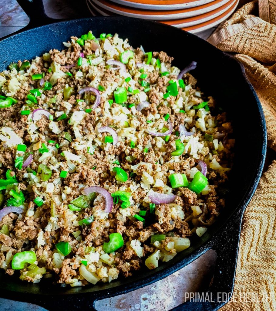 Dirty rice in a black pan.