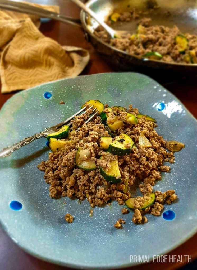 Ground beef veggie skillet on a blue plate.