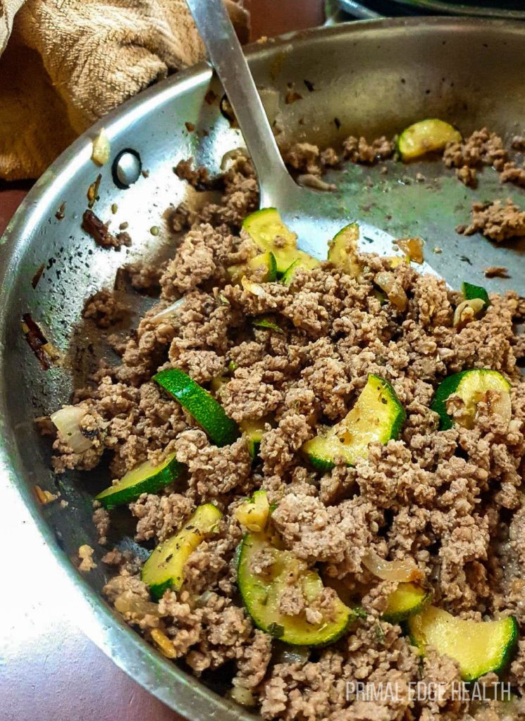 Ground beef veggie in a skillet with a spatula.