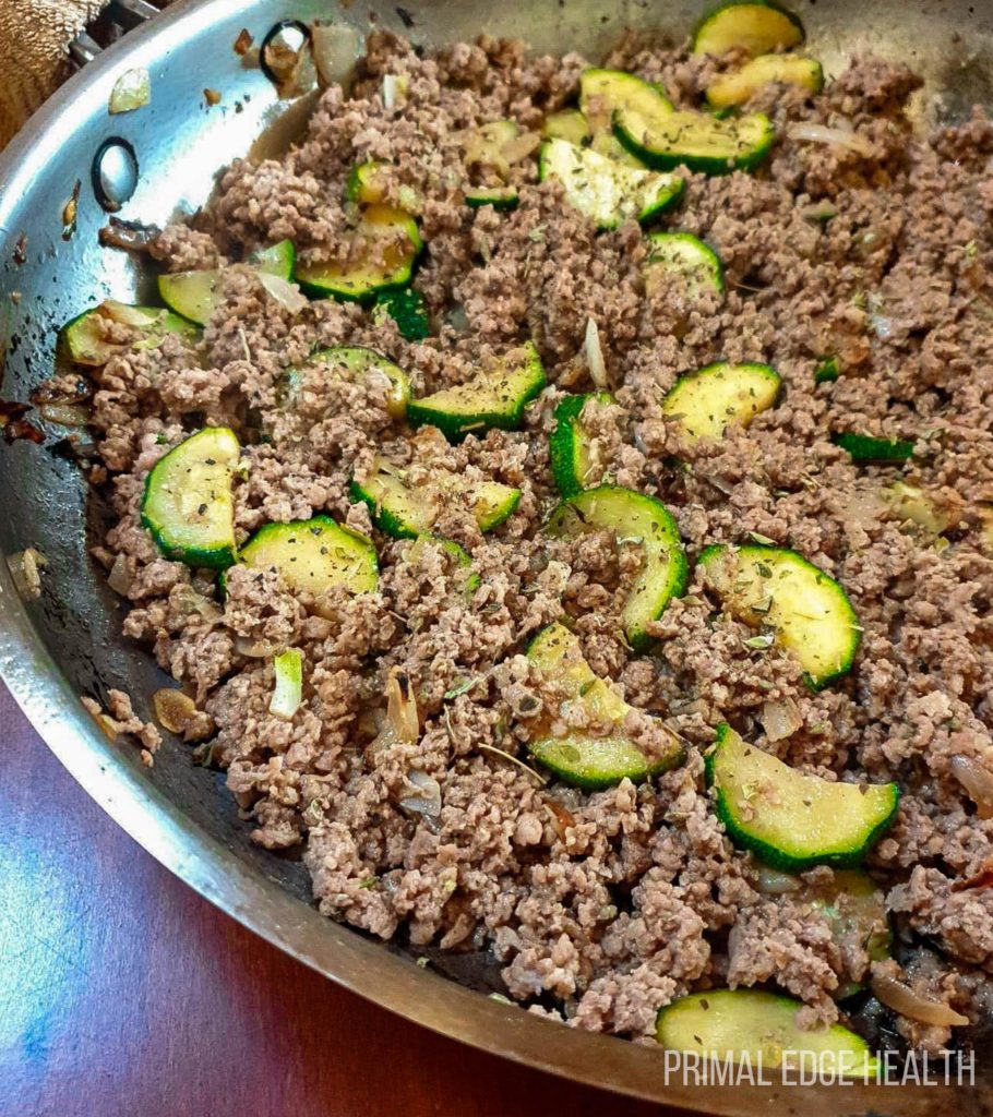 Cooked ground meat and vegetables in a pan.