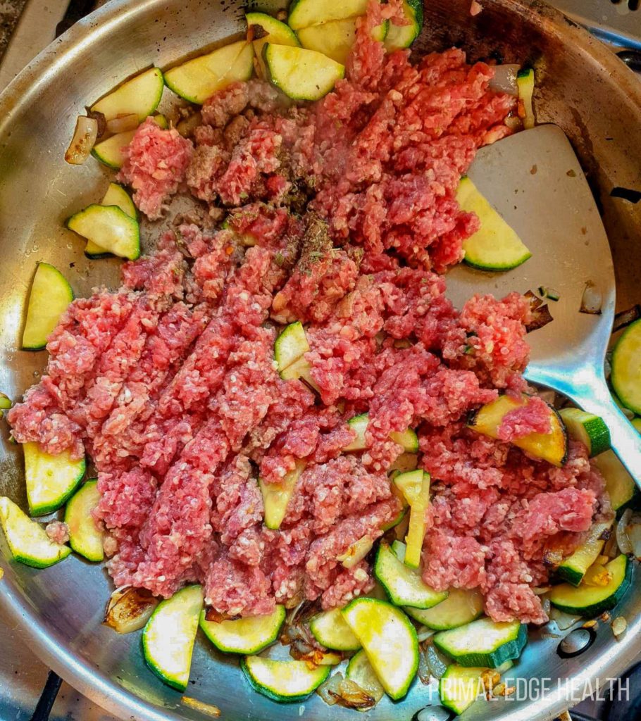 Ground beef and vegetables in a pan.