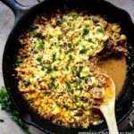 A pan of italian ground beef with a wooden spoon.