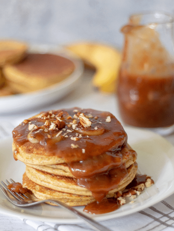 Bananas Foster Pancakes on a plate with a fork.