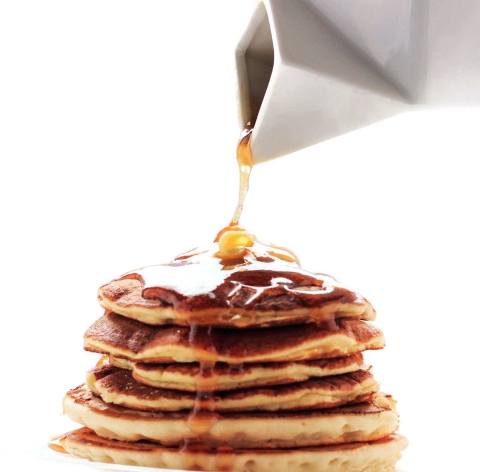 Syrup being poured on easy keto blender pancakes.