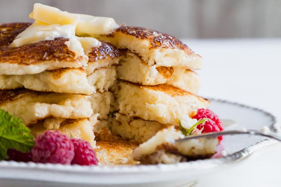 Keto buttermilk pancakes on a plate with a fork.