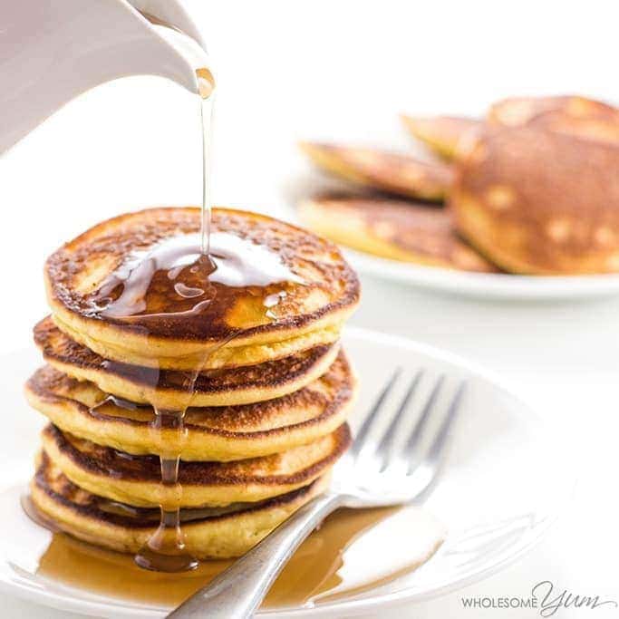 Keto low carb pancakes with syrup on a plate with a fork.