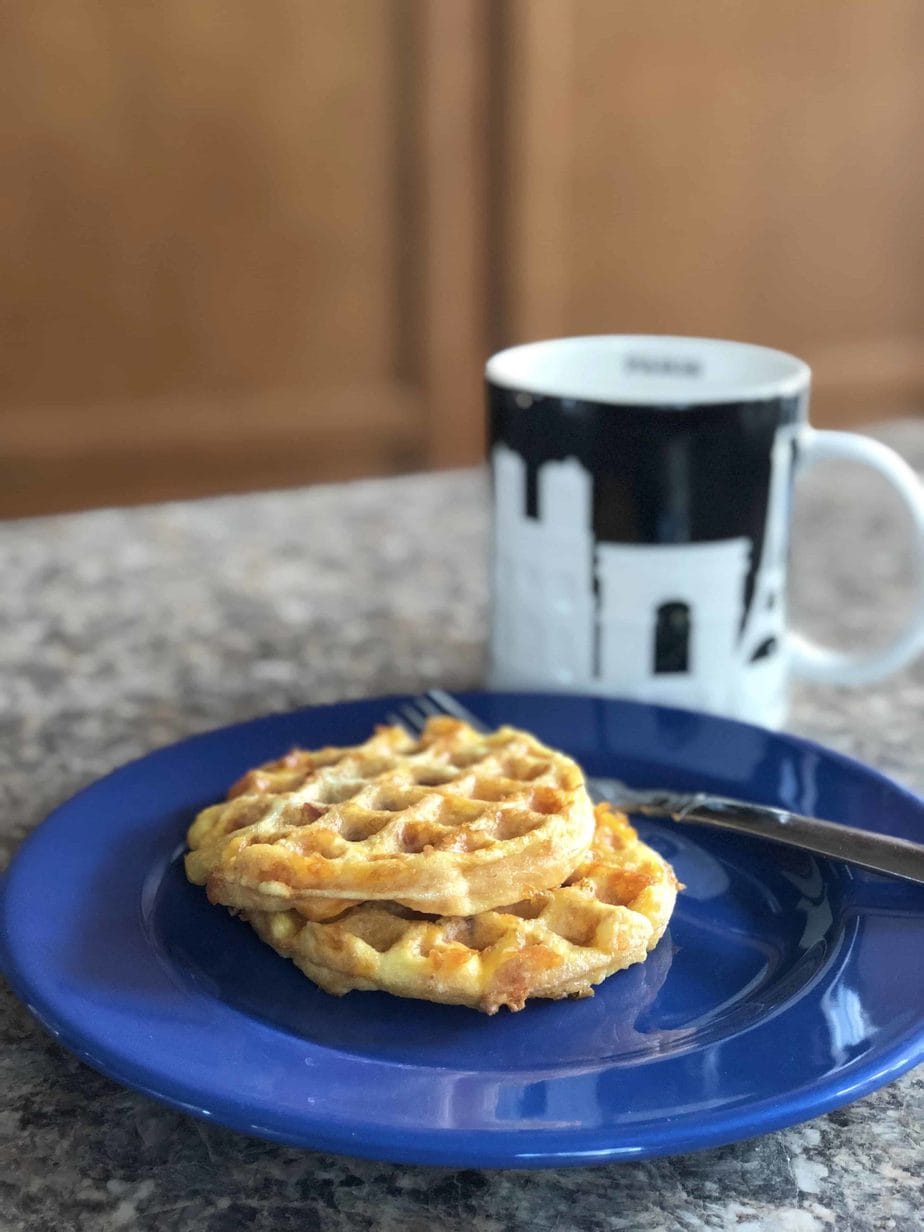 Breakfast Keto Bacon Egg Cheese Chaffles on a blue plate.