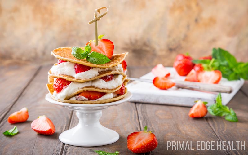 A serving of Keto Strawberry Shortcake Recipe on a wooden surface.