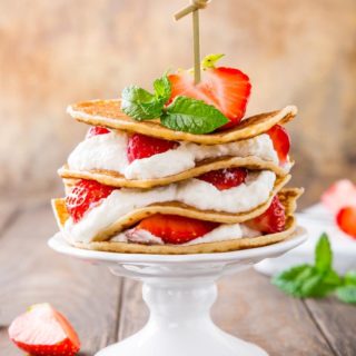 Keto Strawberry Shortcake served with garnish on a wooden surface.