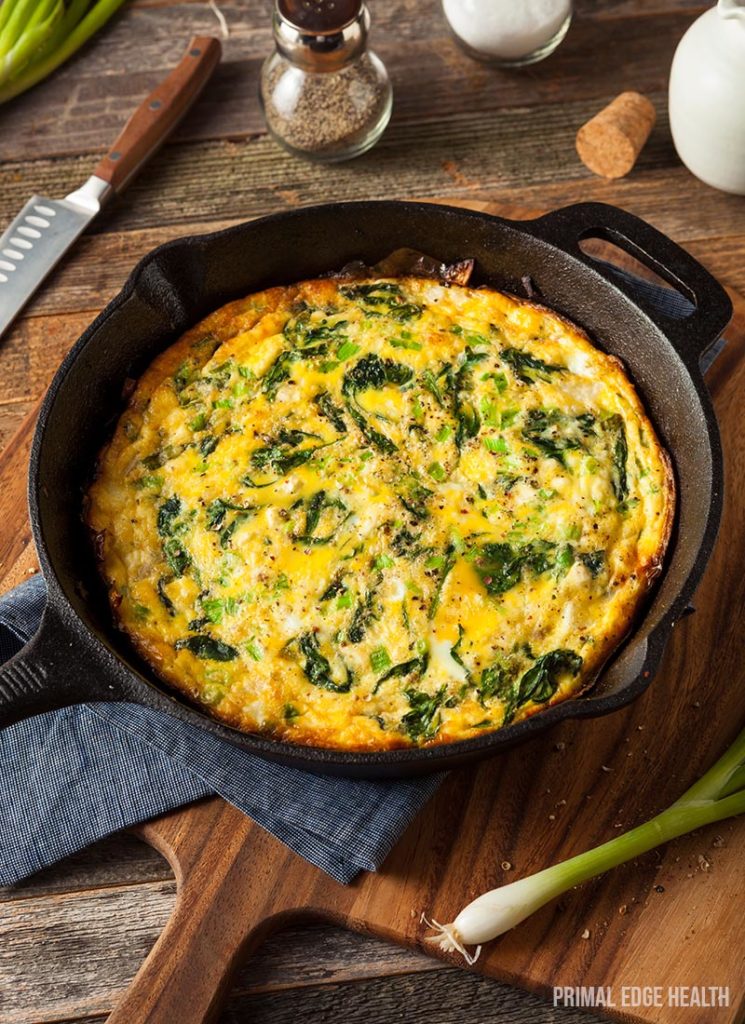 Easy keto frittata in a dark pot on a wooden board.