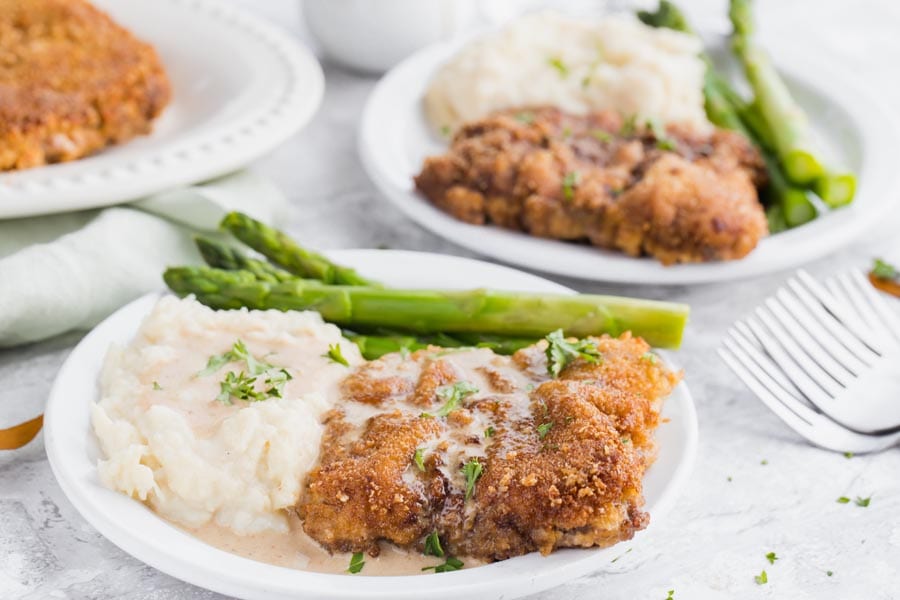 Keto chicken fried steak in a white plate.
