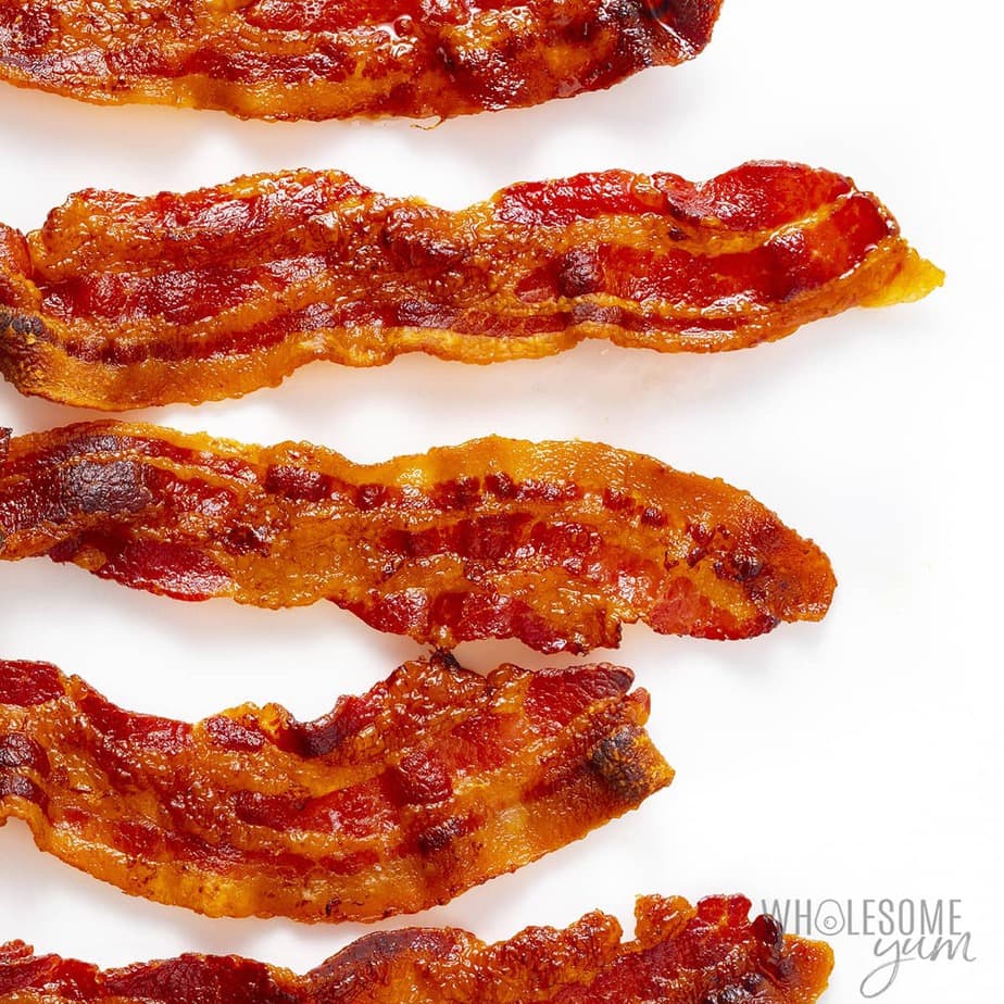 Strips of bacon on a white surface.