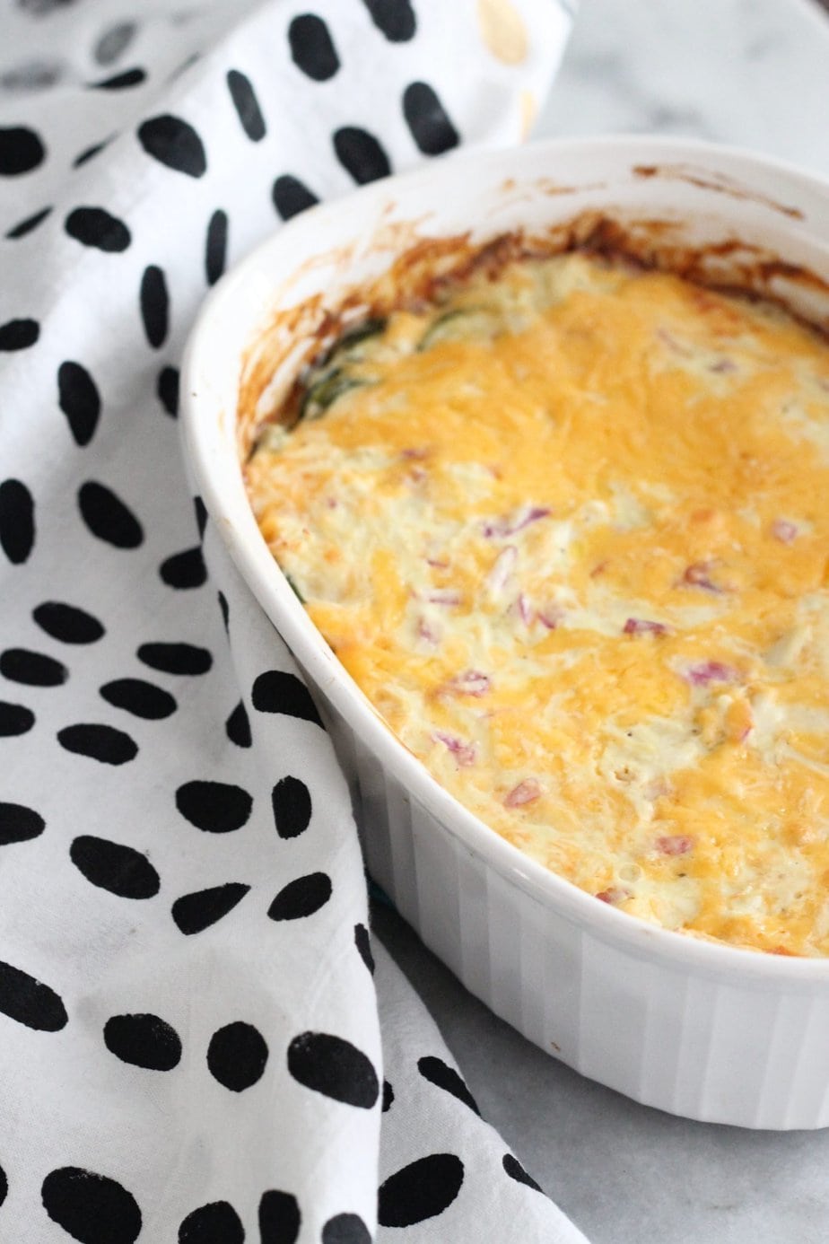 Zucchini casserole in a white dish,