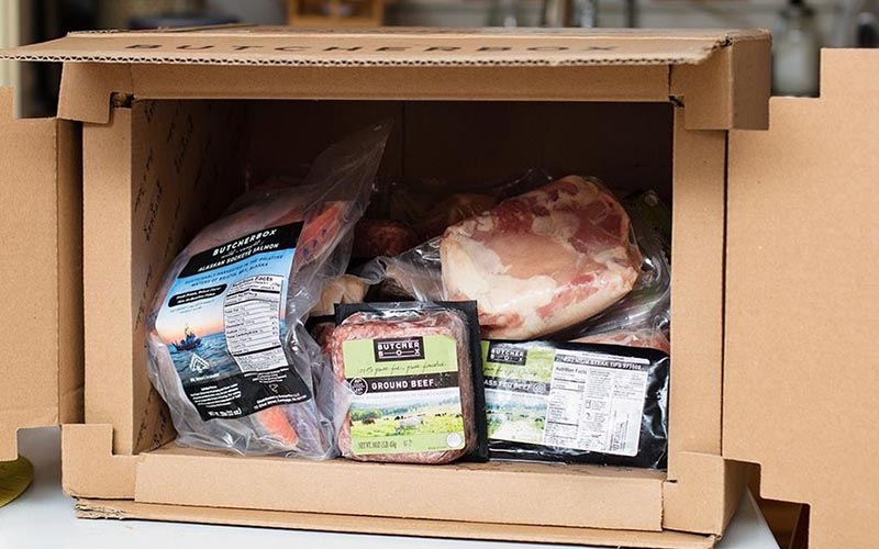 A box with various meat packages inside.