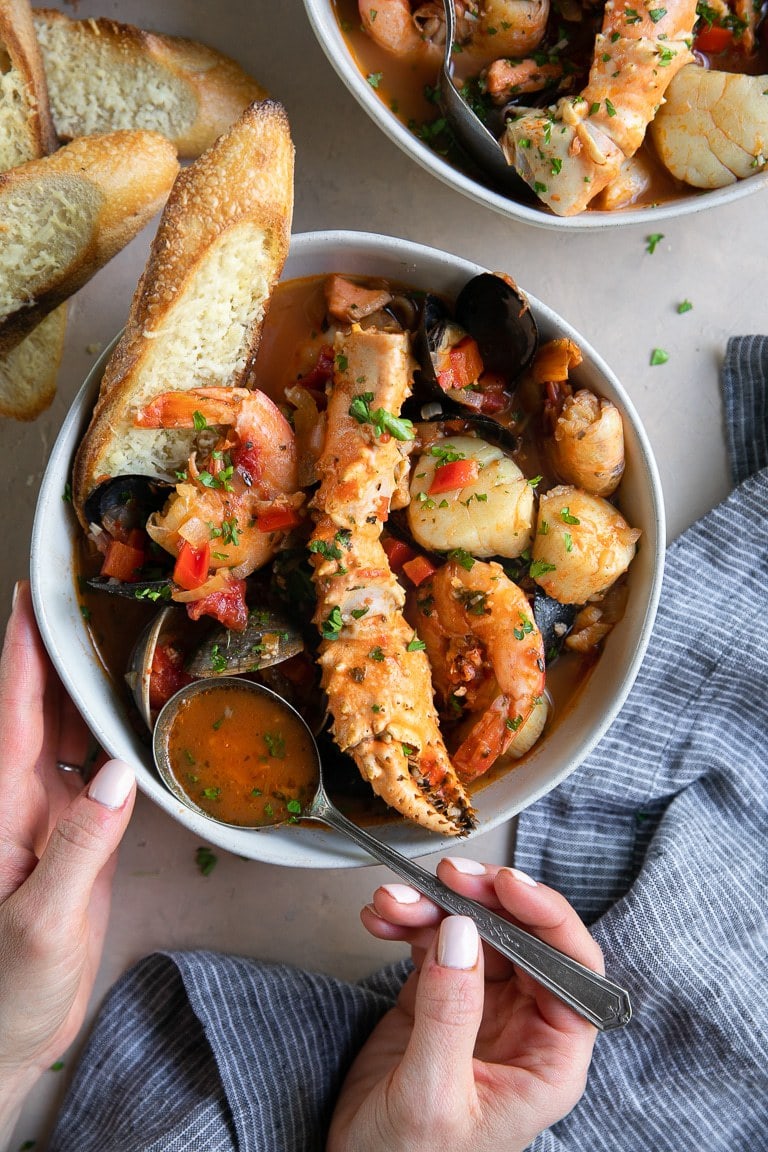 A bowl of Cioppino served with bread.