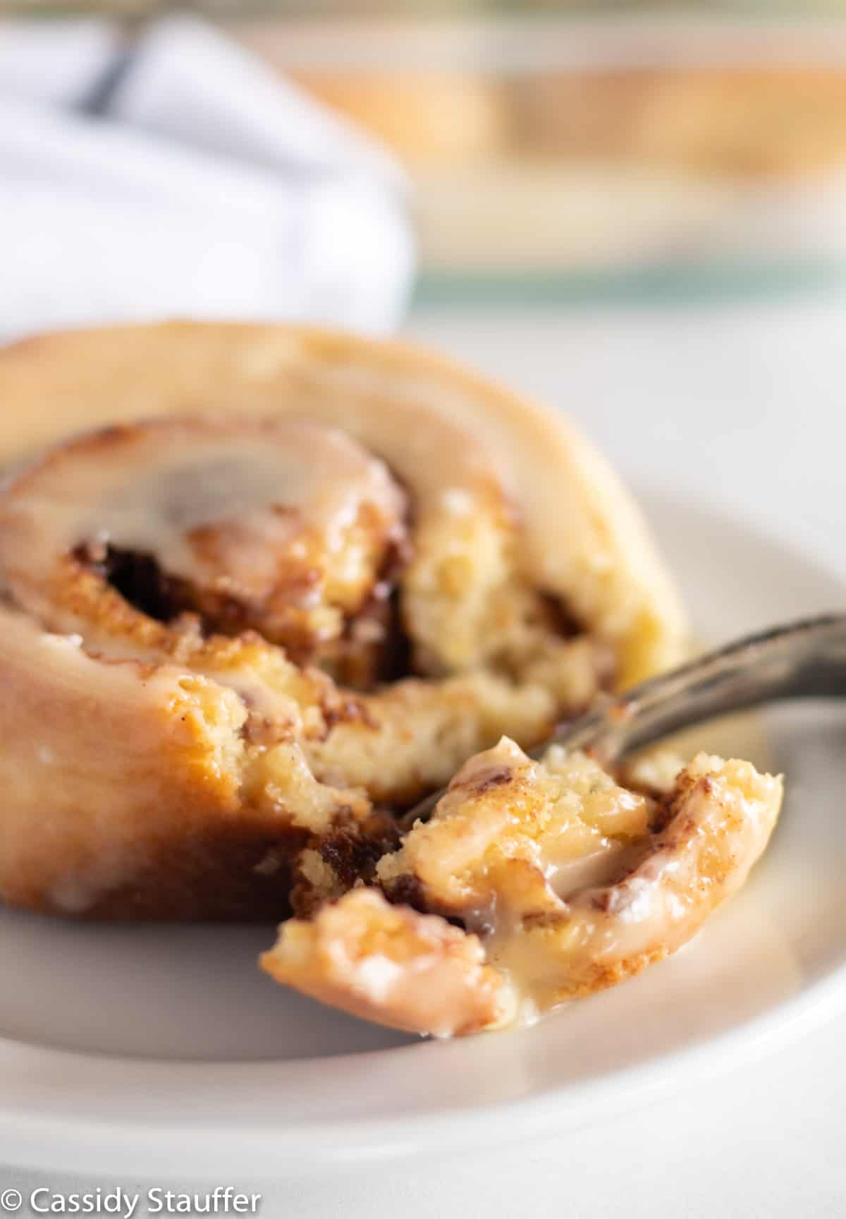 A serving of cinnamon rolls on a white plate.