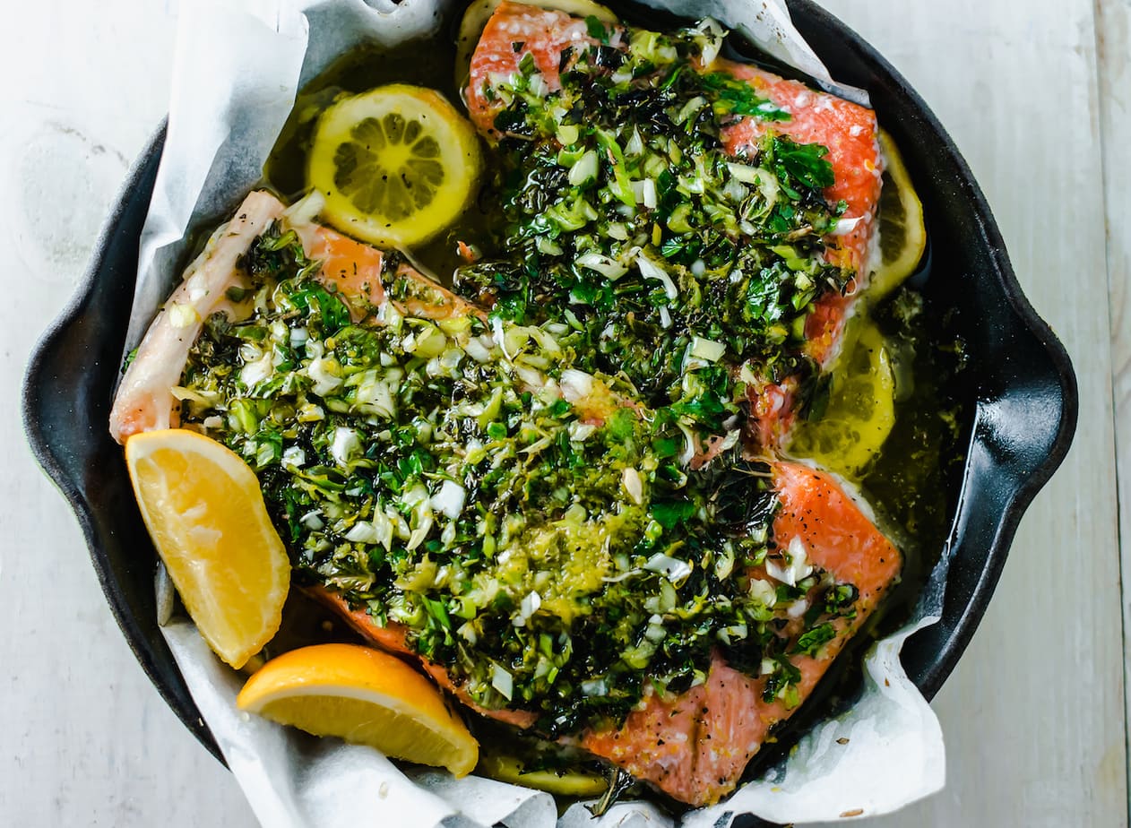 Herb citrus salmon in a black bowl.