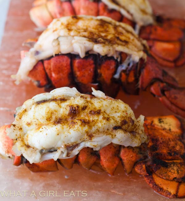 A batch of lobsters sitting on a pink surface.