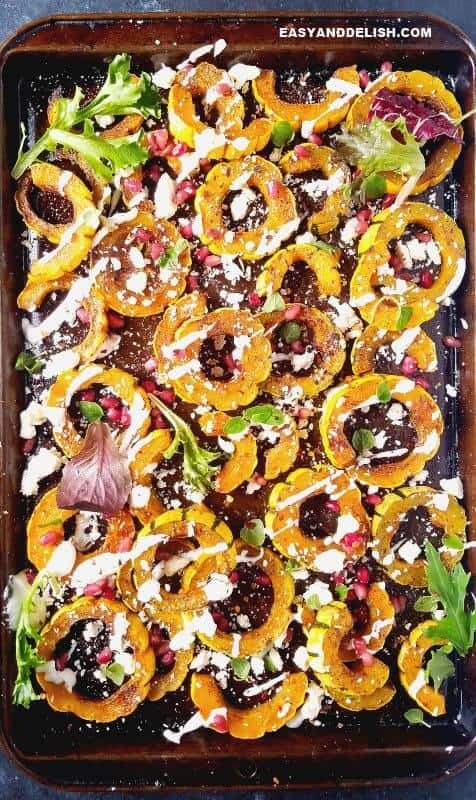 A batch of roasted delicata squash in a tray.