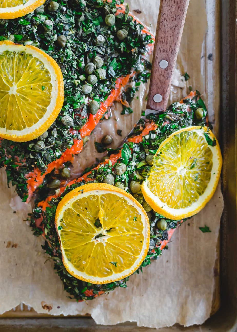 Baked wild sockeye salmon with a slice being taking out of it.