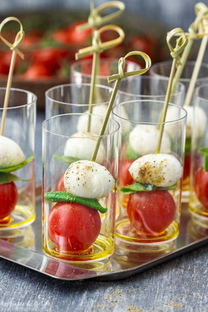 Caprese salad bites in a small glass.