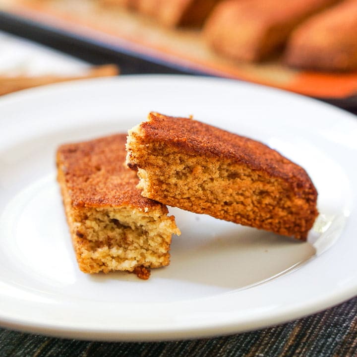 Two pieces of cinnamon biscotti in a white plate.