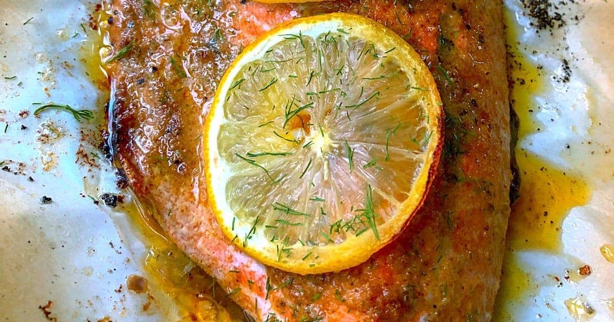 Easy-baked-salmon with a garnish and a slice of lemon.