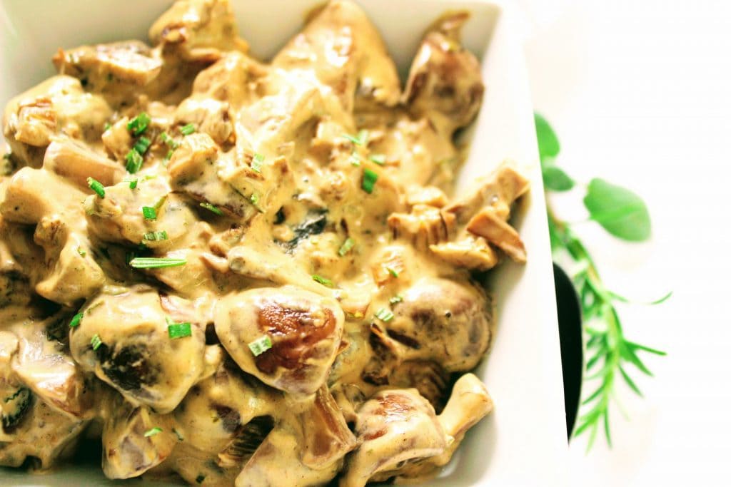 Stroganoff mushrooms in a white dish.