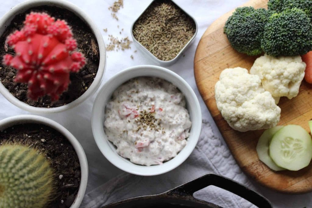 Easy keto dip served with vegetables on a white surface.