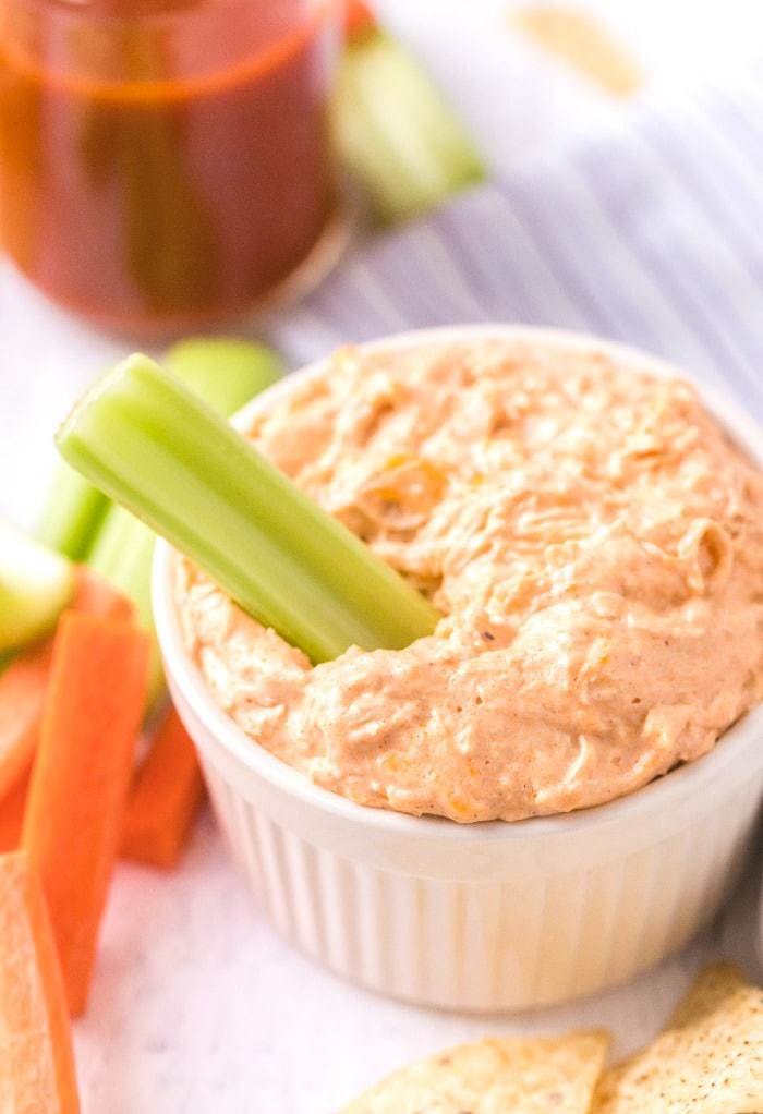 A serving of keto buffalo chicken dip with garnish.