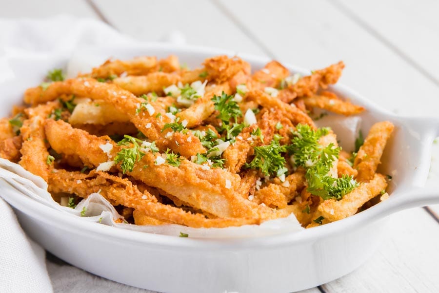 Garlic parmesan keto jicama fries in a white dish.